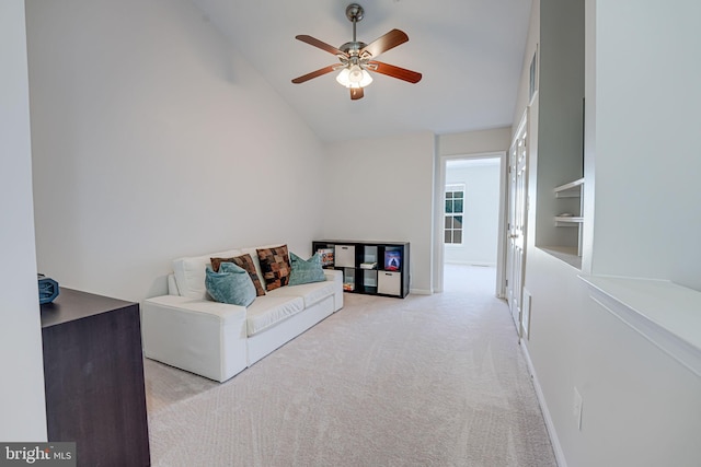 living room featuring lofted ceiling, carpet flooring, ceiling fan, and baseboards