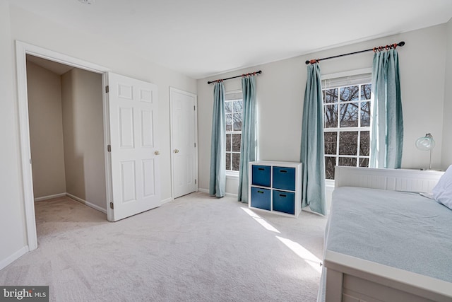 unfurnished bedroom featuring carpet floors and baseboards