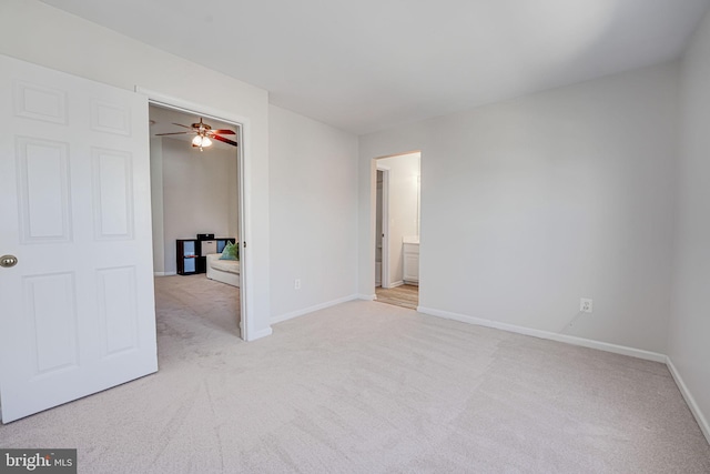 carpeted empty room featuring baseboards