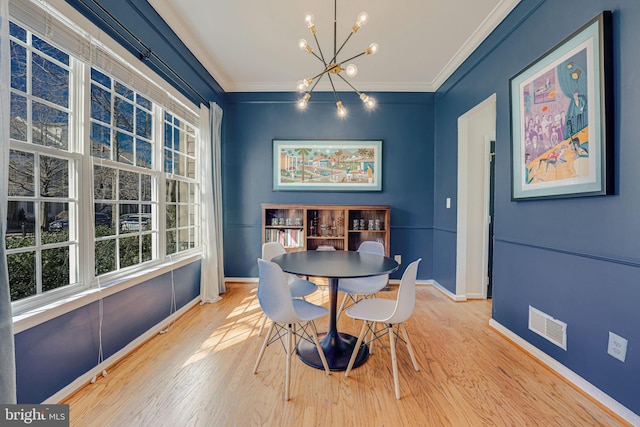 dining space featuring ornamental molding, visible vents, and wood finished floors