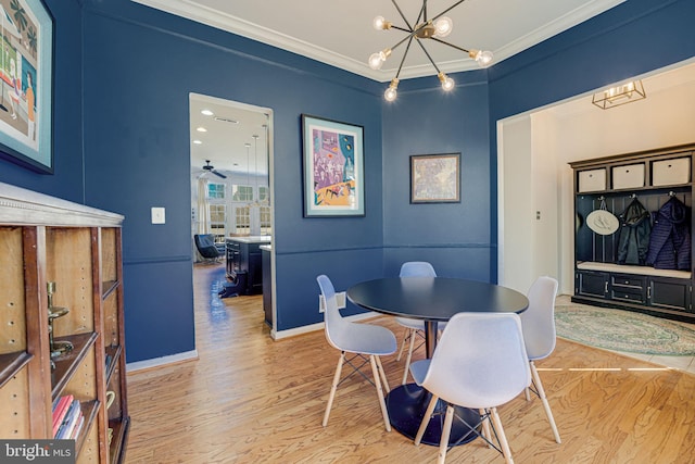 dining room with ornamental molding, baseboards, an inviting chandelier, and wood finished floors