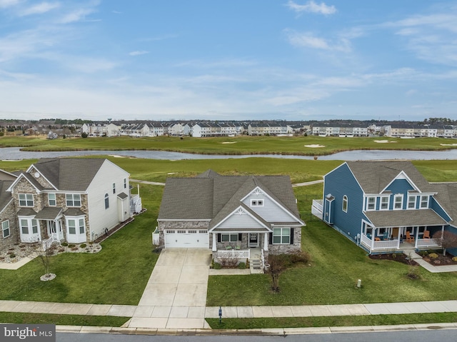 bird's eye view featuring a residential view and a water view