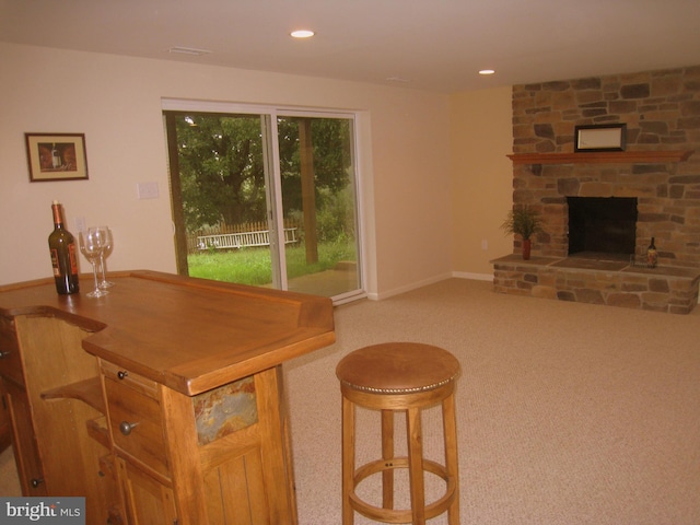 interior space featuring baseboards, carpet floors, a fireplace, and recessed lighting