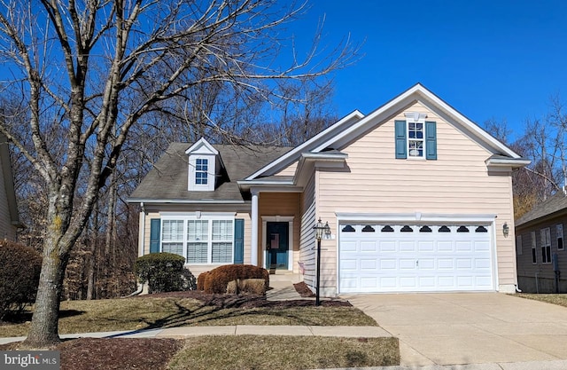 traditional home with a garage and concrete driveway