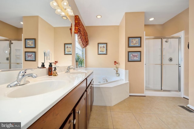 bathroom with a stall shower, a sink, a bath, and tile patterned floors