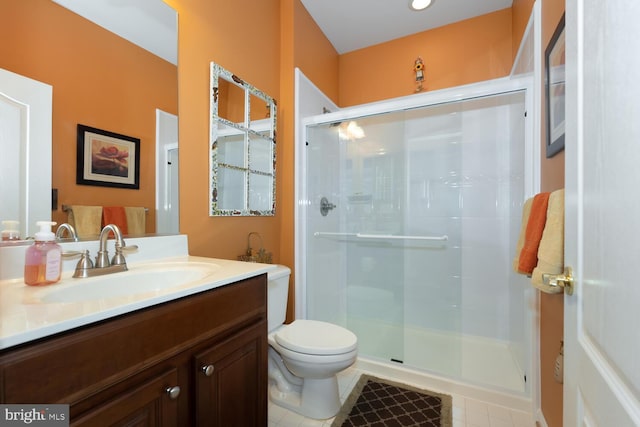 full bath with toilet, a stall shower, tile patterned flooring, and vanity