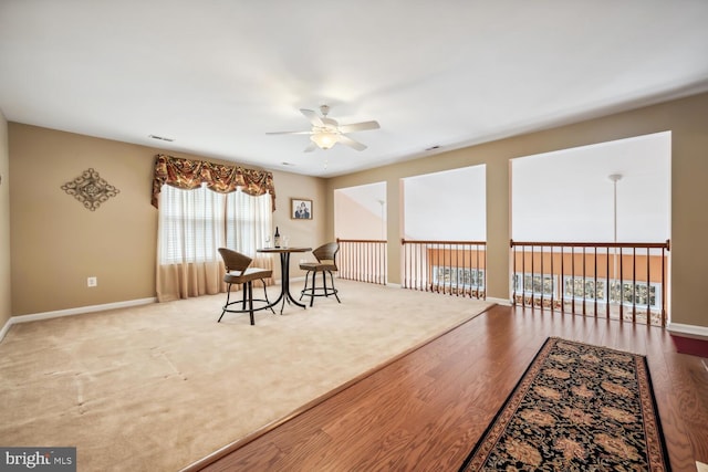 dining area featuring ceiling fan, baseboards, and wood finished floors