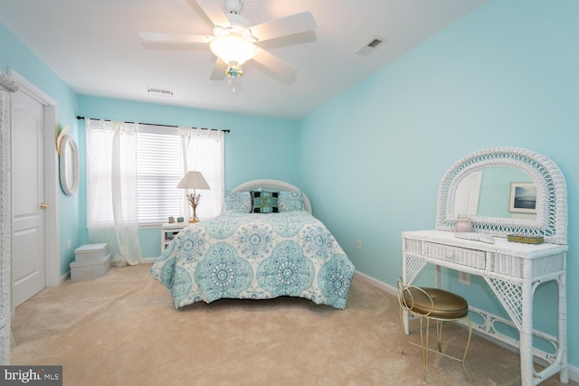 carpeted bedroom with ceiling fan, visible vents, and baseboards