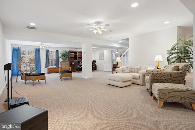 carpeted living room featuring baseboards, visible vents, a ceiling fan, stairway, and recessed lighting