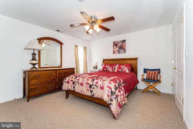 bedroom featuring a ceiling fan, visible vents, light carpet, and baseboards