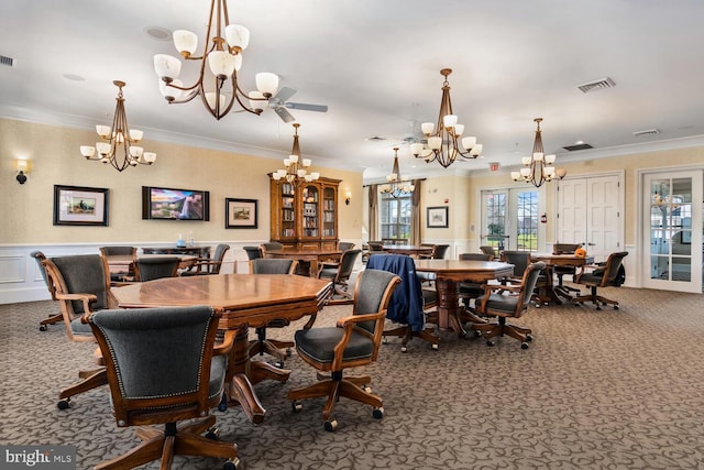 carpeted dining area featuring visible vents, a wainscoted wall, ornamental molding, an inviting chandelier, and french doors