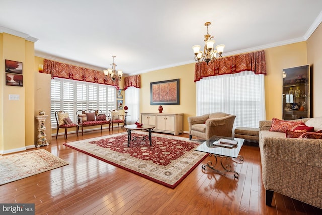 living area featuring ornamental molding, hardwood / wood-style flooring, and a notable chandelier