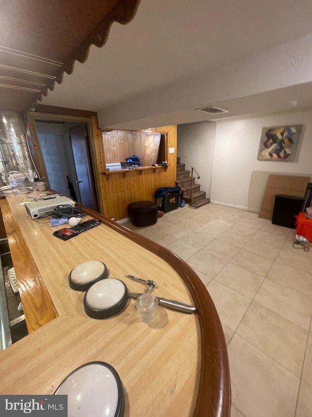 dining area with stairway, tile patterned floors, and baseboards