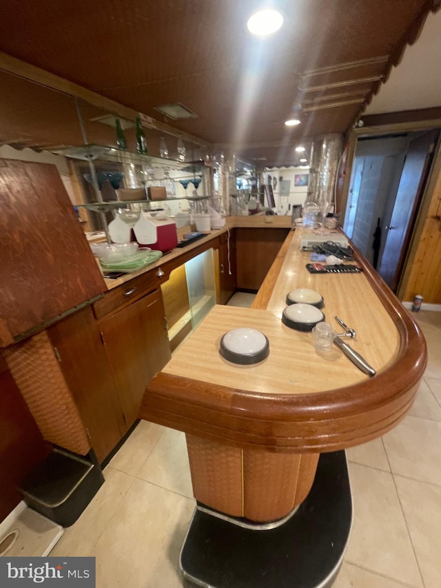 bar featuring light tile patterned flooring and indoor bar