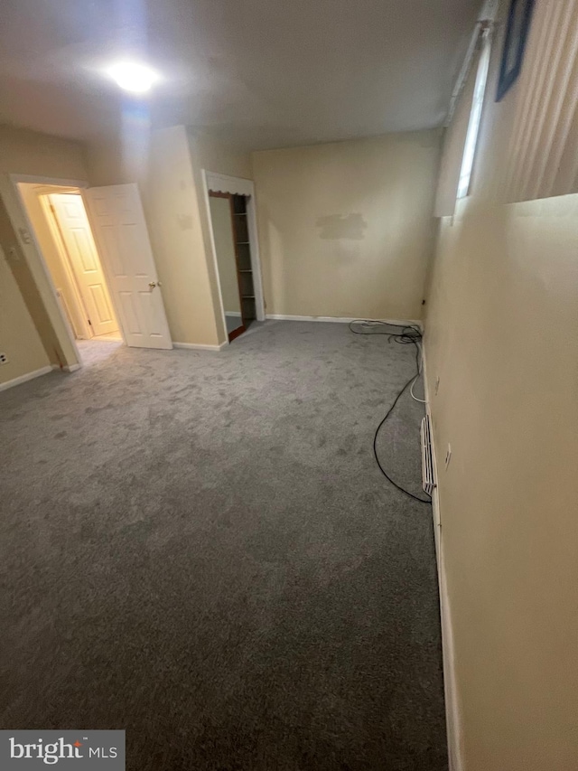 interior space with baseboards and carpet floors