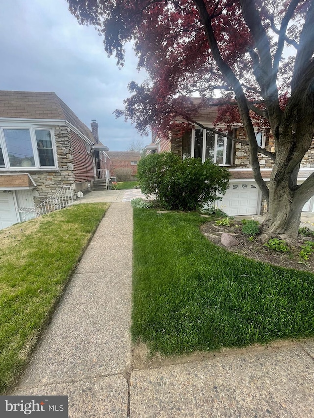 exterior space featuring a yard and a garage