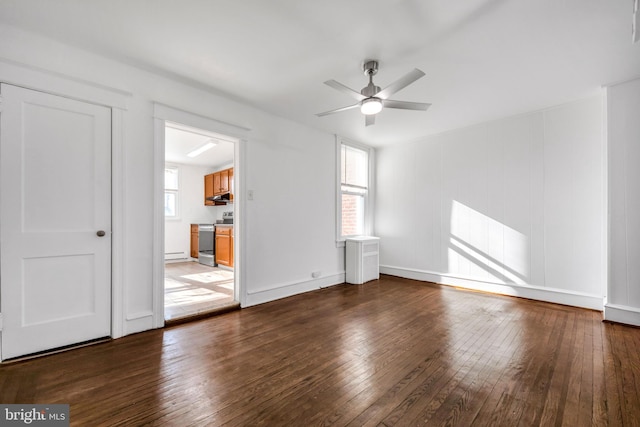 unfurnished room with a ceiling fan, baseboards, and hardwood / wood-style floors