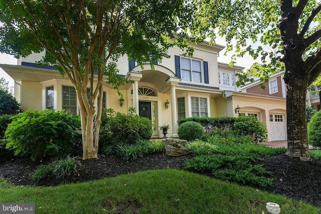 view of front of home with brick siding and an attached garage