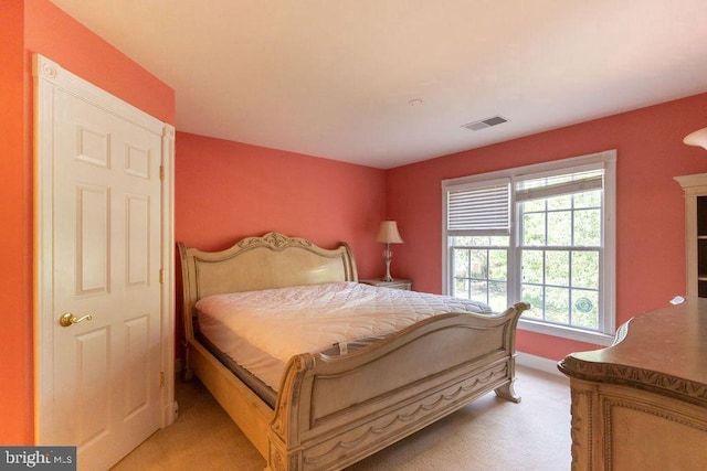 bedroom with visible vents and light colored carpet