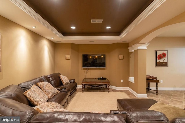 home theater room with arched walkways, recessed lighting, visible vents, a tray ceiling, and ornate columns