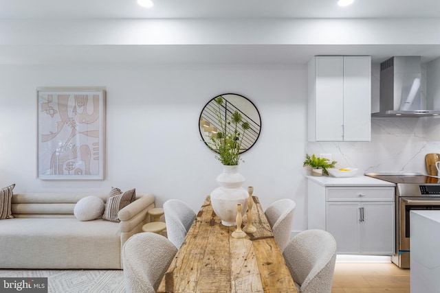 dining space with light wood-style flooring and recessed lighting