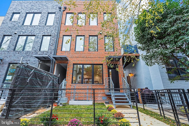 view of front of house with brick siding and a fenced front yard