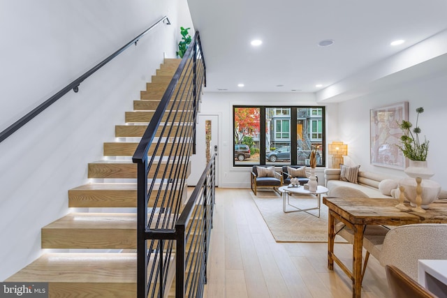 stairs with wood-type flooring and recessed lighting