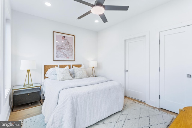 bedroom with recessed lighting, ceiling fan, and light wood-style flooring