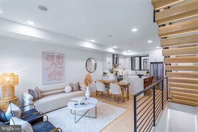 living room featuring light wood-type flooring and recessed lighting