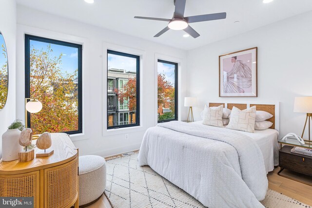 bedroom with wood finished floors, a ceiling fan, and recessed lighting