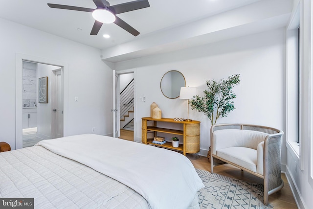 bedroom with recessed lighting, ensuite bathroom, a ceiling fan, wood finished floors, and baseboards