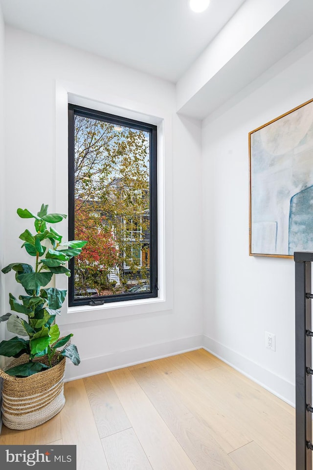 interior space featuring baseboards and wood finished floors