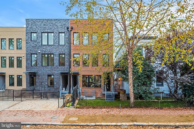 view of property with fence and brick siding