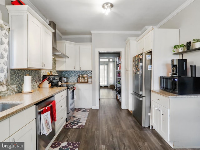 kitchen with stainless steel appliances, dark wood-type flooring, white cabinetry, wall chimney exhaust hood, and tasteful backsplash