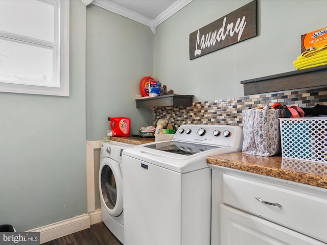 laundry room featuring dark wood finished floors, ornamental molding, washing machine and dryer, laundry area, and baseboards