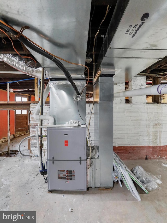 utility room featuring heating unit