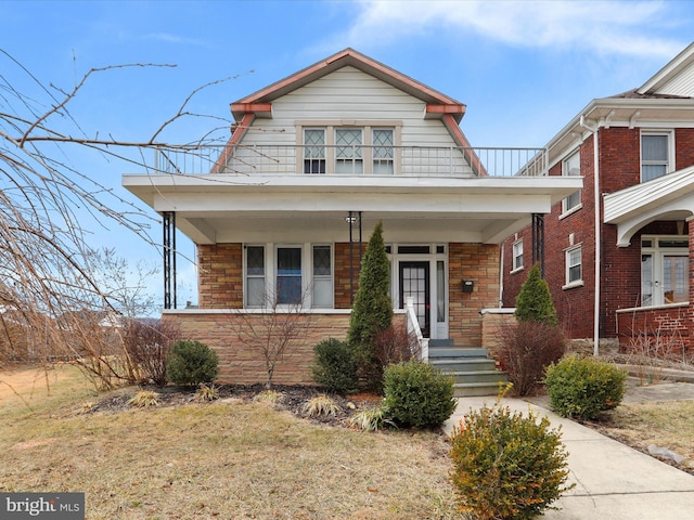 view of front of house featuring french doors, a porch, and a gambrel roof