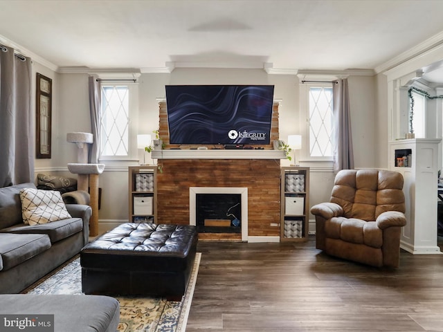 sitting room featuring baseboards, a fireplace, wood finished floors, and crown molding