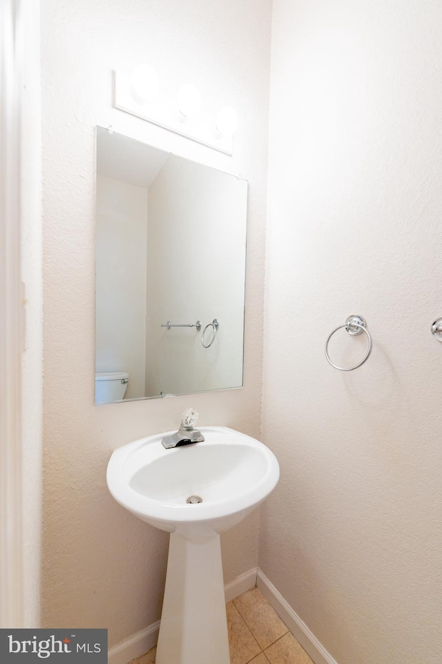 bathroom featuring baseboards and tile patterned floors