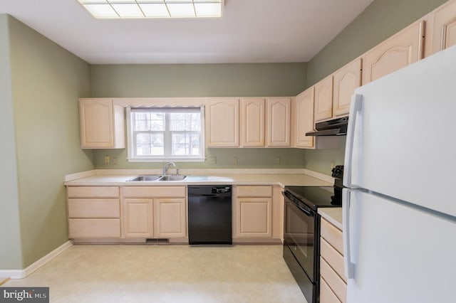 kitchen featuring light countertops, light brown cabinets, a sink, under cabinet range hood, and black appliances