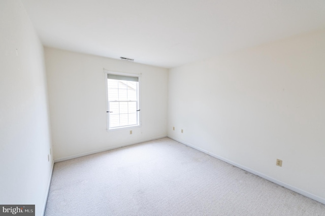 unfurnished room with baseboards, visible vents, and carpet flooring