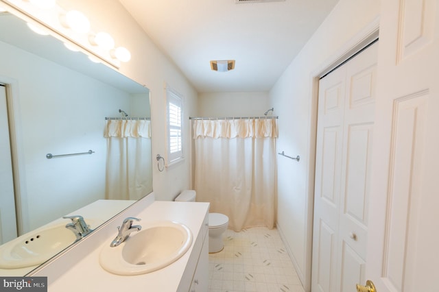 full bathroom with curtained shower, toilet, vanity, baseboards, and tile patterned floors