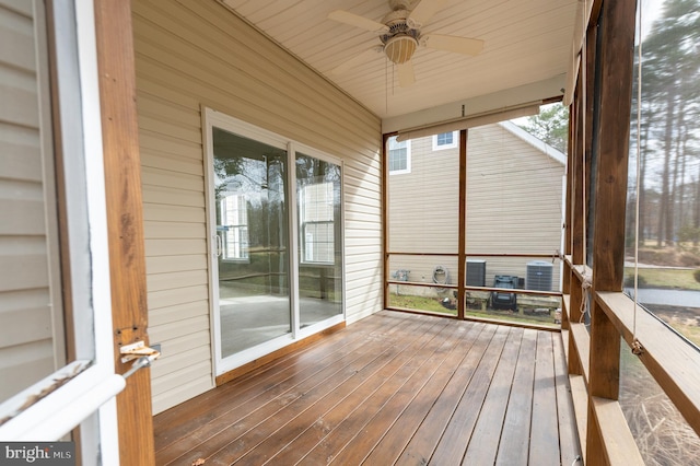 unfurnished sunroom featuring a ceiling fan