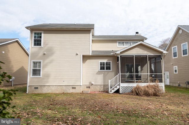 back of property featuring crawl space, a sunroom, a chimney, and a lawn