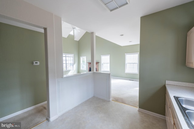 bathroom featuring lofted ceiling, baseboards, a ceiling fan, and a sink