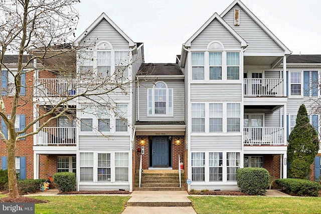 townhome / multi-family property featuring brick siding