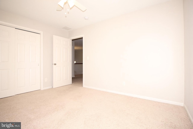 unfurnished bedroom with a ceiling fan, a closet, carpet flooring, and baseboards