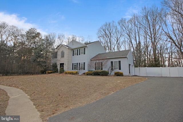 view of front of property featuring fence