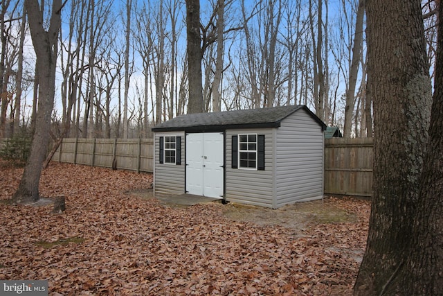 view of outdoor structure with an outbuilding and a fenced backyard