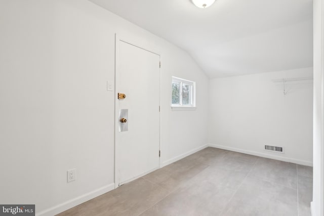 entryway featuring lofted ceiling, baseboards, and visible vents